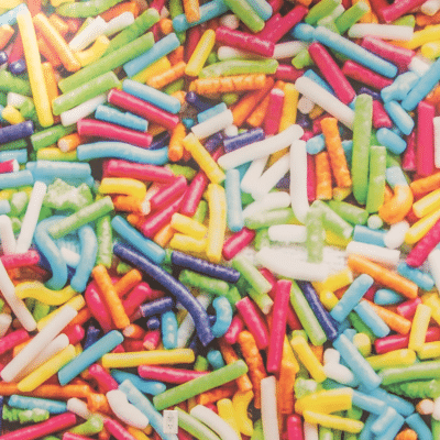 An assortment of different colored candy, representing october is halloween & national orthodontic health month