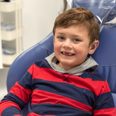 Little boy sitting in dental chair at commerce park children’s dentistry & orthodontics our story