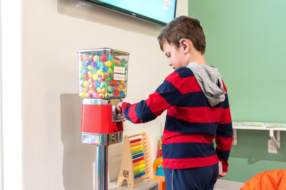 Patient using gumball machine in lobby on financial information page