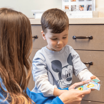 Little boy talking to a dental specialist, representing early dental care for kids