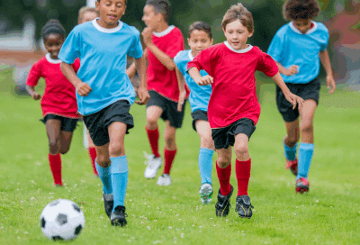 A group of kids playing football, representing mouthguards for kids