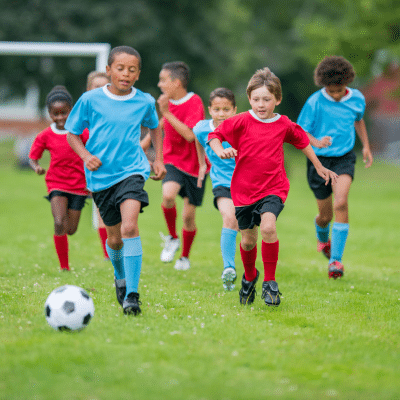 A group of kids playing football, representing mouthguards for kids